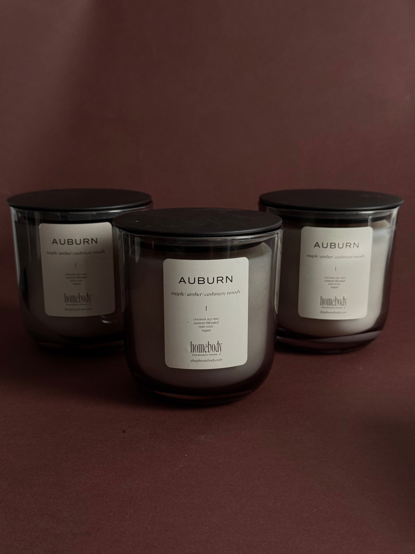 Auburn fall candle on brown background.